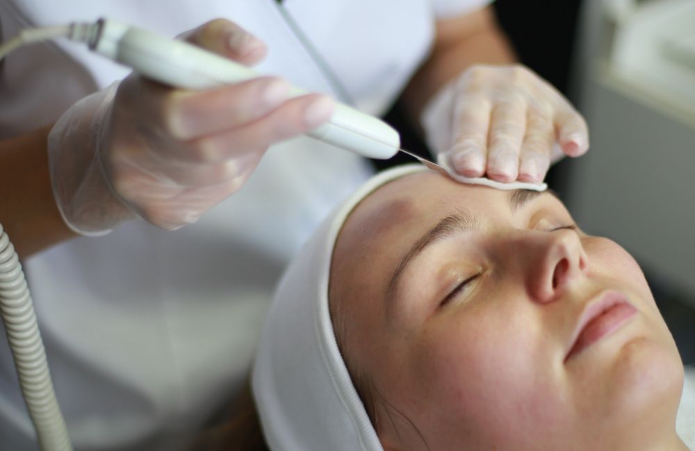 Stock photograph: Hands-on professional facial treatment; not Valeon staff, patients, or results