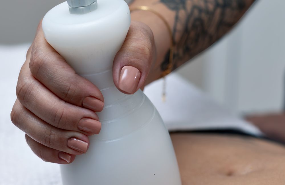 Stock photograph: Body contouring handpiece applied to the abdomen; not Valeon staff, patients, or results